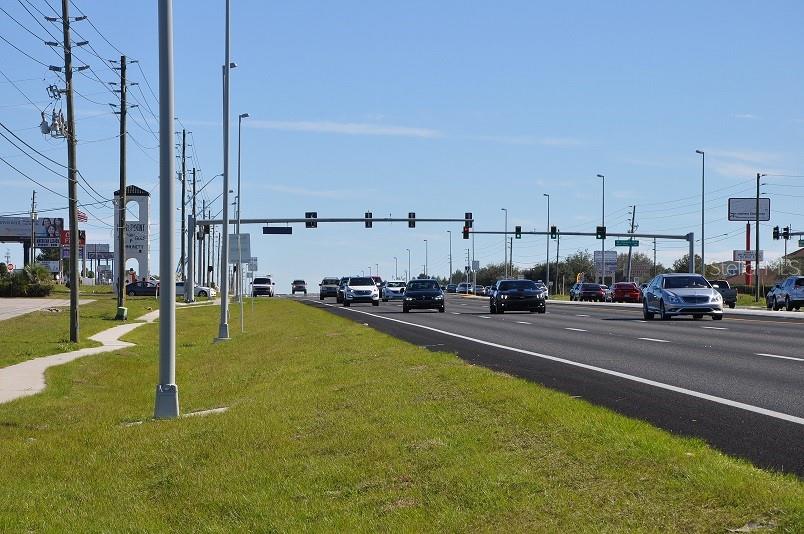 A multi-lane road with traffic and utility poles under a clear blue sky — 11507 CORTEZ BOULEVARD UNIT 102, BROOKSVILLE, FL