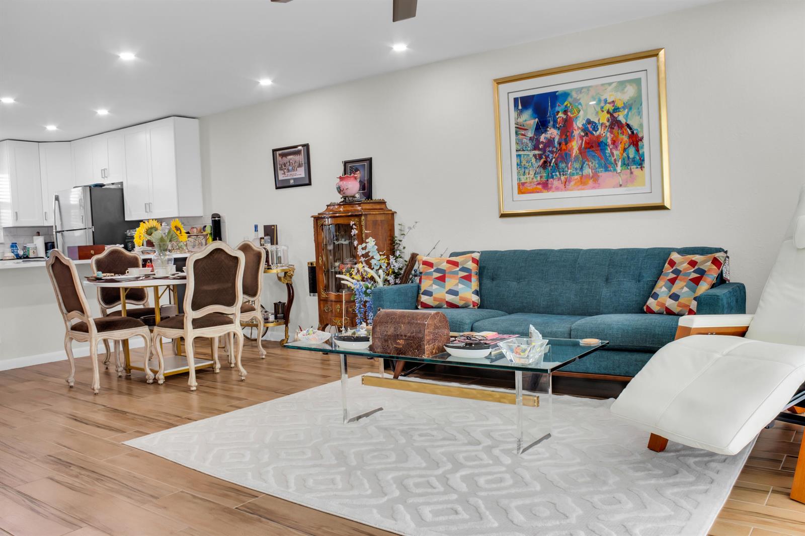 A living room features a blue sofa, a glass coffee table, and an adjacent dining area — 2202 NE 36th Street # 15, Lighthouse Point FL 33064, LIGHTHOUSE POINT, FL