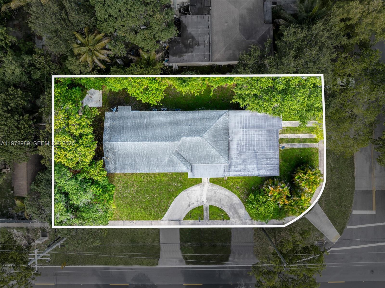 An aerial view shows a house with a circular driveway surrounded by trees and landscaping — 12090 NW 12th Ave, North Miami FL 33168, NORTH MIAMI, FL