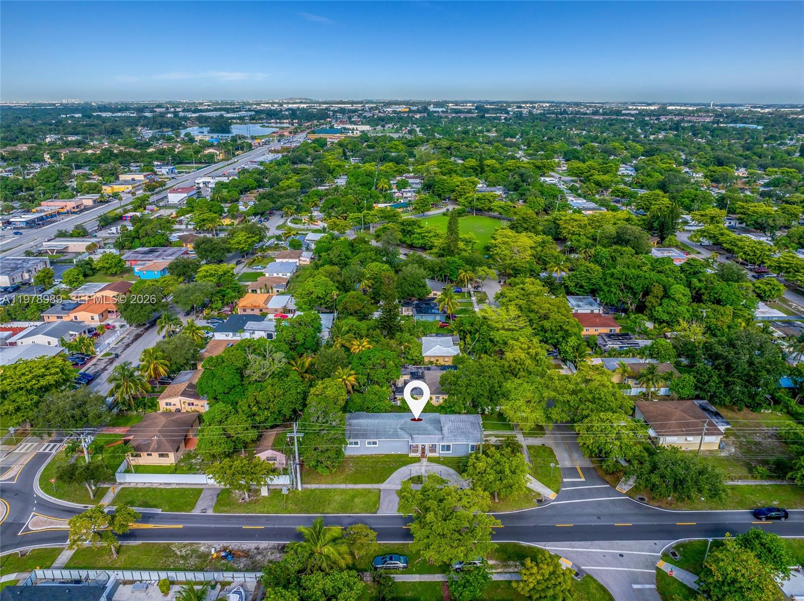 An aerial view shows a single-story house with a white roof in a residential neighborhood — 12090 NW 12th Ave, North Miami FL 33168, NORTH MIAMI, FL