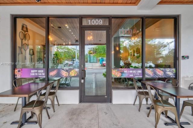 The exterior of a restaurant storefront features a glass door, windows, and outdoor patio seating — S University Dr, Plantation FL 33324, PLANTATION, FL