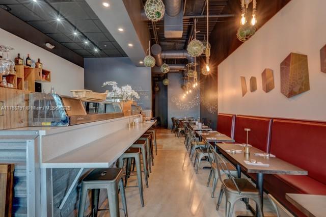 A restaurant interior features a long bar with stools and a row of booth seating — S University Dr, Plantation FL 33324, PLANTATION, FL