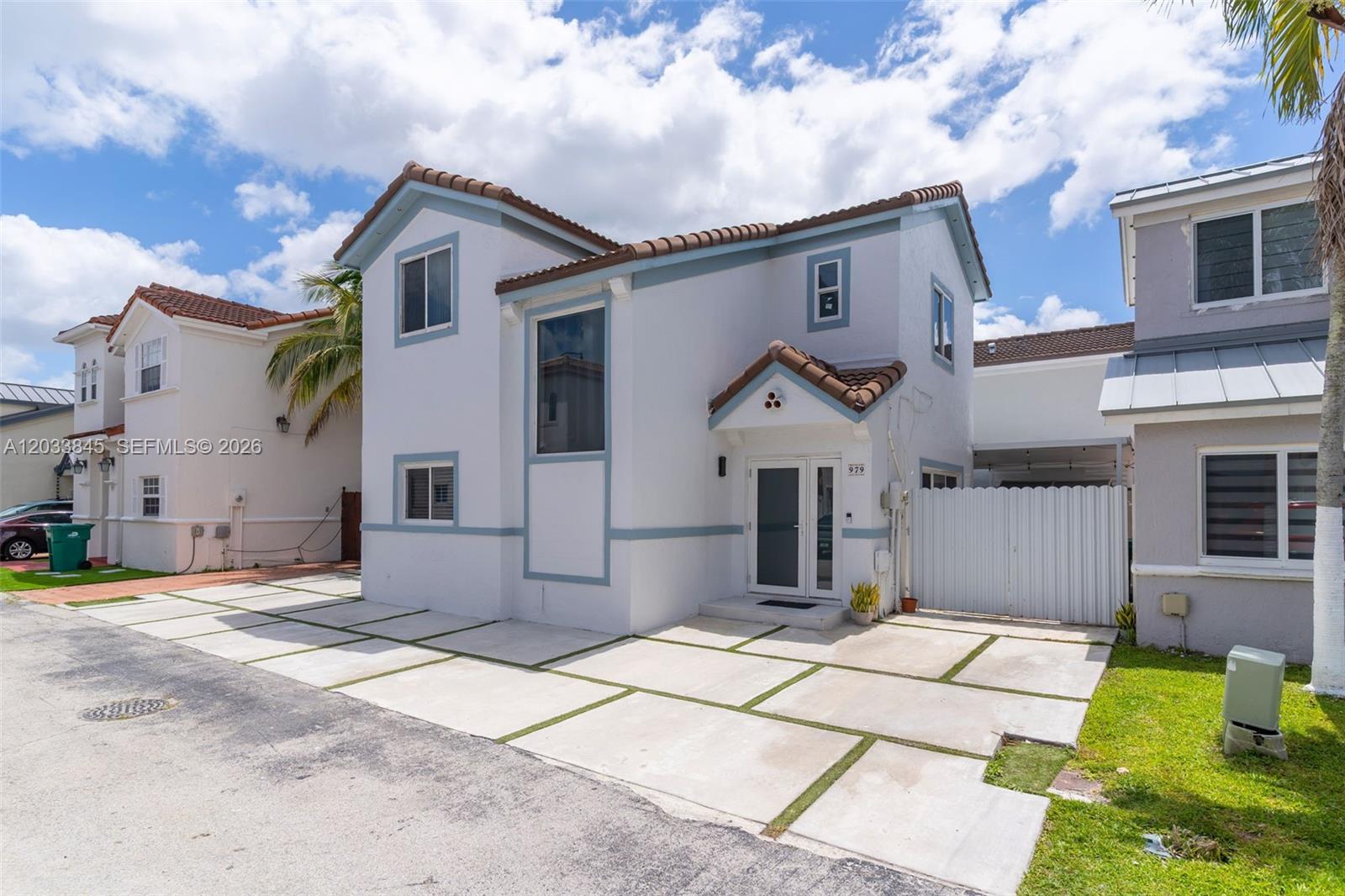 A two-story white house with a tiled roof and a concrete paver driveway — 979 NW 126th Path, Miami FL 33182, MIAMI, FL