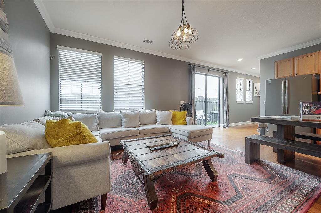 A living room features a sectional sofa, a wooden coffee table, and a dining area — 111 S PACKWOOD AVENUE UNIT C, TAMPA, FL