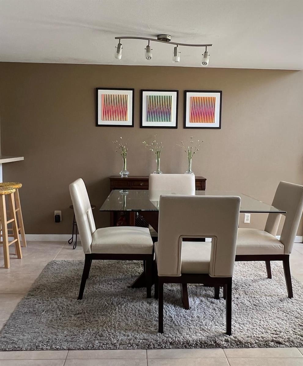 A dining room features a glass-topped table, four upholstered chairs, and three framed wall prints — 1002 Bridgewood Place # 1002, Boca Raton FL 33434, BOCA RATON, FL