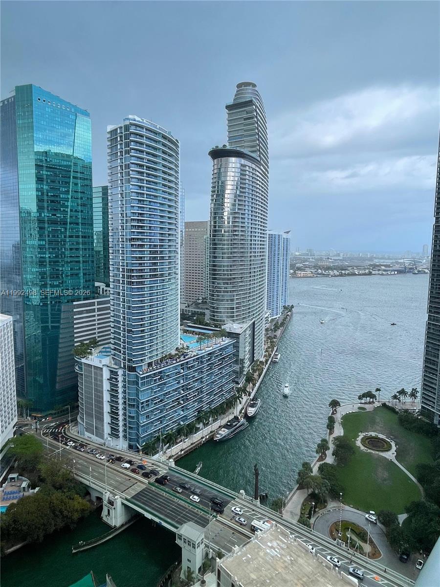 An elevated view of a Miami waterfront featuring modern skyscrapers, a bridge, and a park — 77 SE 5th St # 2204, Miami FL 33131, MIAMI, FL