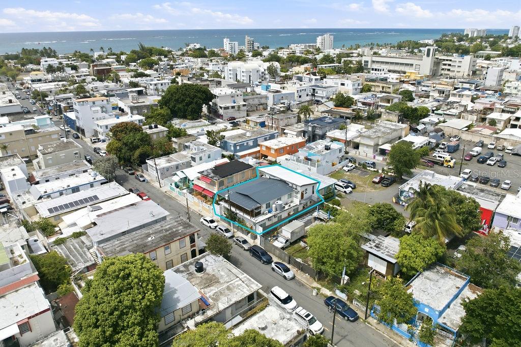 An aerial view shows a residential neighborhood with a highlighted house near the coast — 119 SANTA CECILIA, SAN JUAN, PR