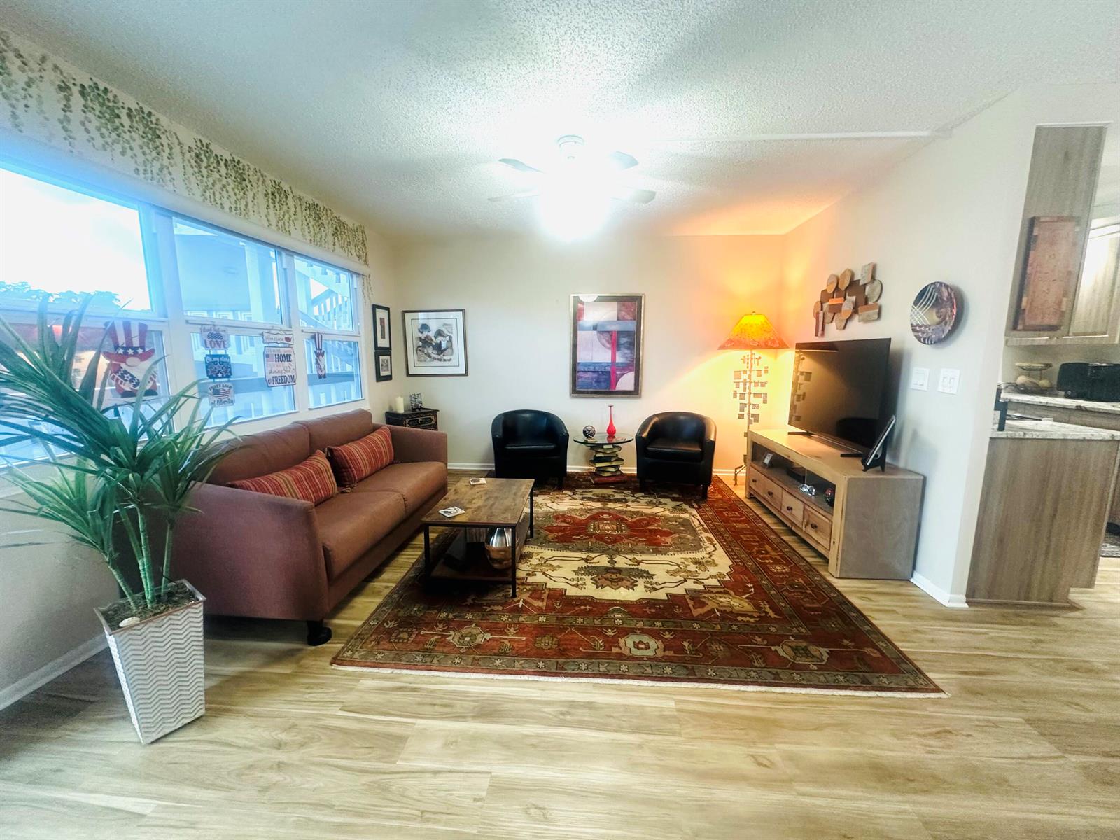 A living room and dining area feature light wood flooring, a ceiling fan, and furniture — 2157 Cambridge G # 2157, Deerfield Beach FL 33442, DEERFIELD BEACH, FL