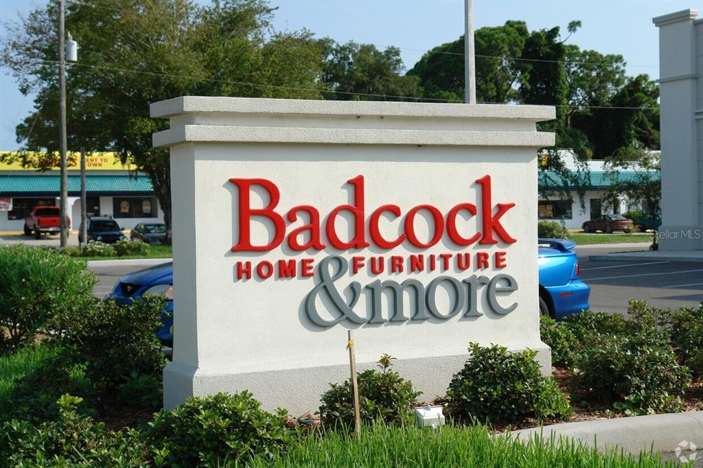 A freestanding monument sign for Badcock Home Furniture & more stands in a parking lot — 311 S RIDGEWOOD AVENUE, EDGEWATER, FL