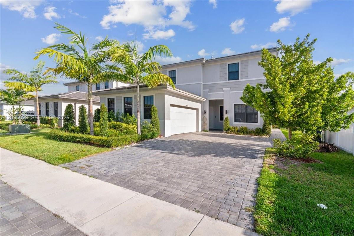 A two-story house with a paved driveway, palm trees, and a white garage door — 17333 SW 46th St, Miramar FL 33029, MIRAMAR, FL