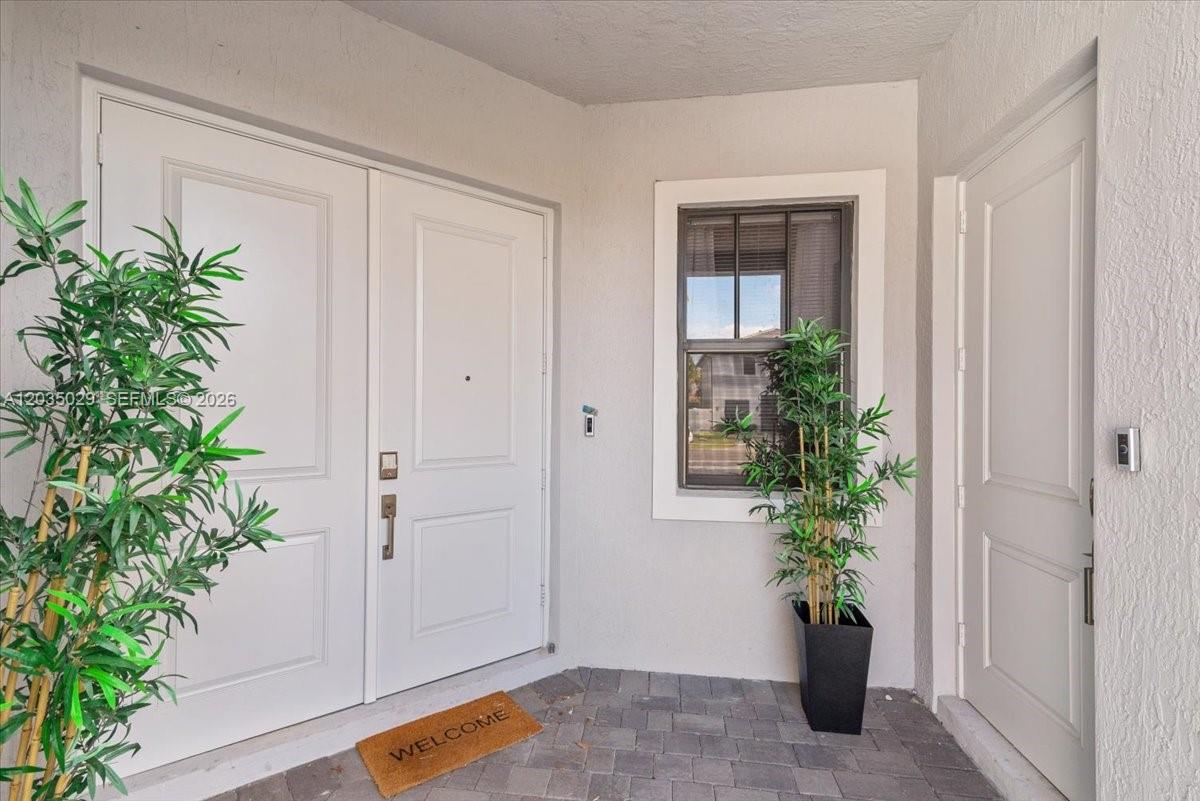 A front entryway features double white doors, a window, and a potted plant — 17333 SW 46th St, Miramar FL 33029, MIRAMAR, FL