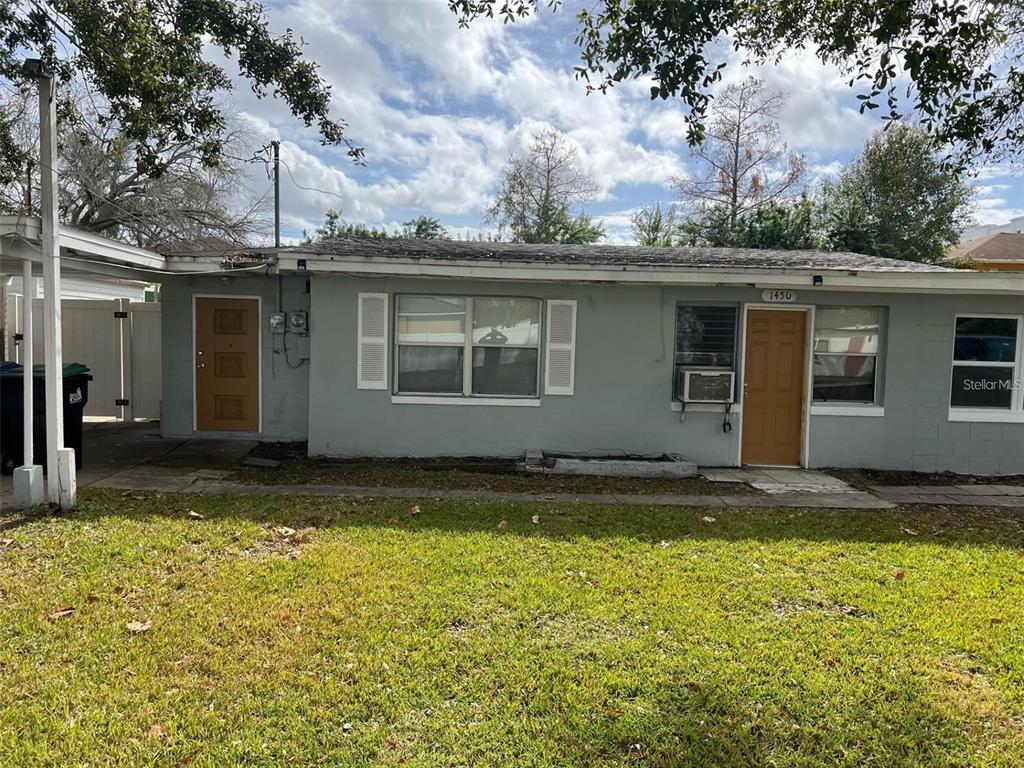 A single-story gray house with two brown doors and a front lawn — 1450 WAKULLA WAY, ORLANDO, FL