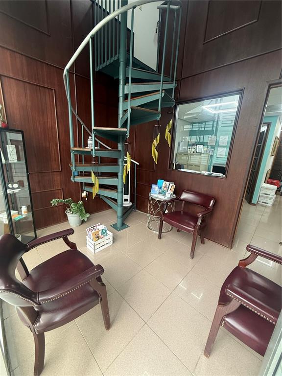 A waiting room features a spiral staircase, wood-paneled walls, tile flooring, and three leather chairs — 201 AVE ARTERIAL HOSTO, SAN JUAN, PR