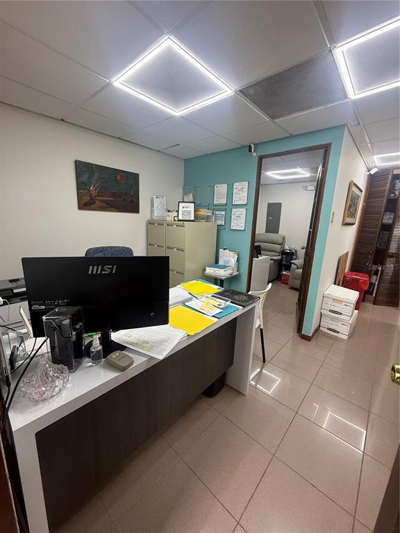 An office space features a desk with a computer, filing cabinets, and tiled flooring — 201 AVE ARTERIAL HOSTO, SAN JUAN, PR