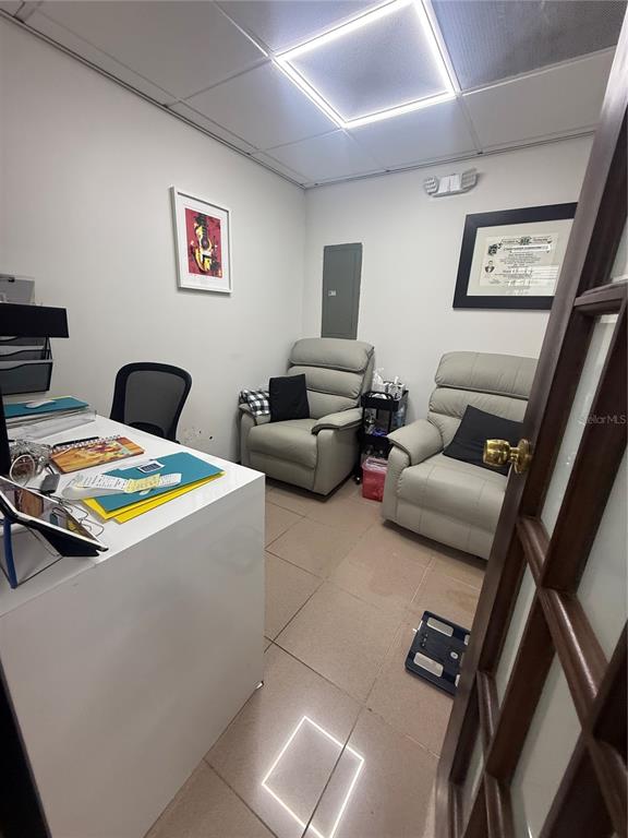 A small office features a white desk, two light-colored recliners, and tiled flooring — 201 AVE ARTERIAL HOSTO, SAN JUAN, PR