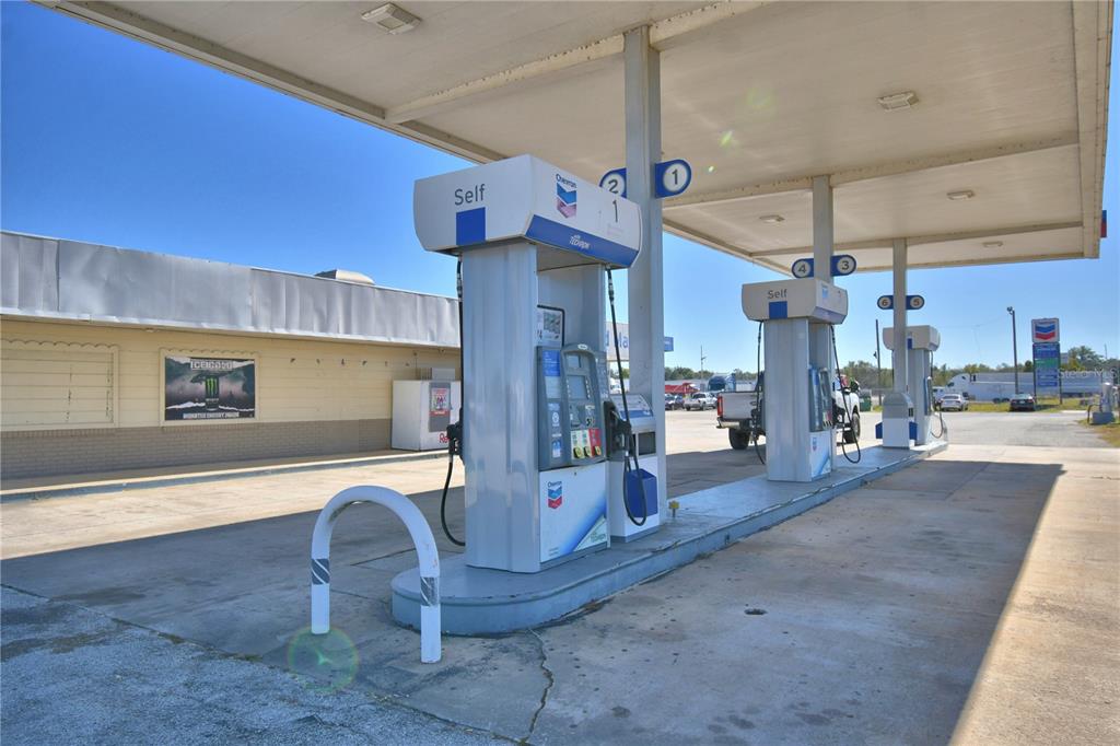 A gas station exterior features multiple fuel pumps under a large metal canopy — 16311 HWY 27, LAKE WALES, FL