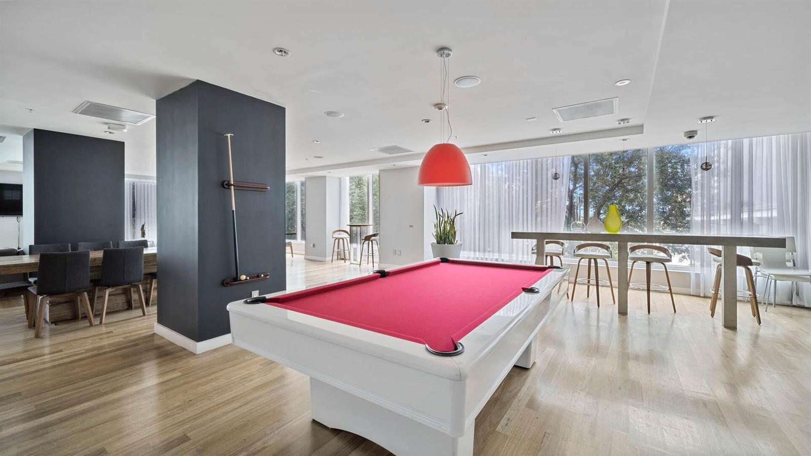 A modern recreation room features a red pool table, a long bar, and dining area — 133 NE 2nd Avenue # 1408, Miami FL 33132, MIAMI, FL