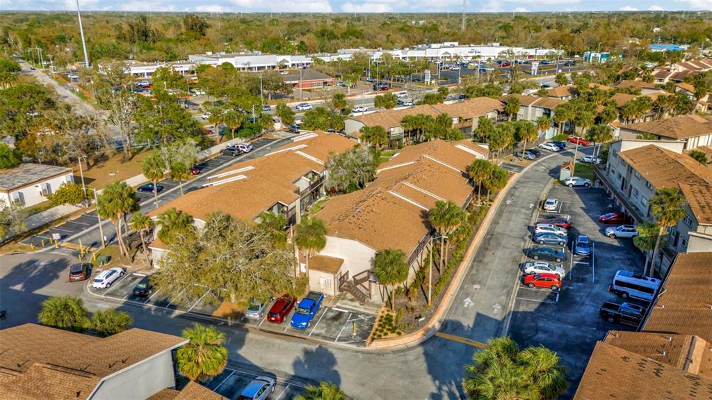 An aerial view shows a multi-unit residential complex with parking lots and surrounding trees — 6320 NEWTOWN CIRCLE UNIT 20B1, TAMPA, FL