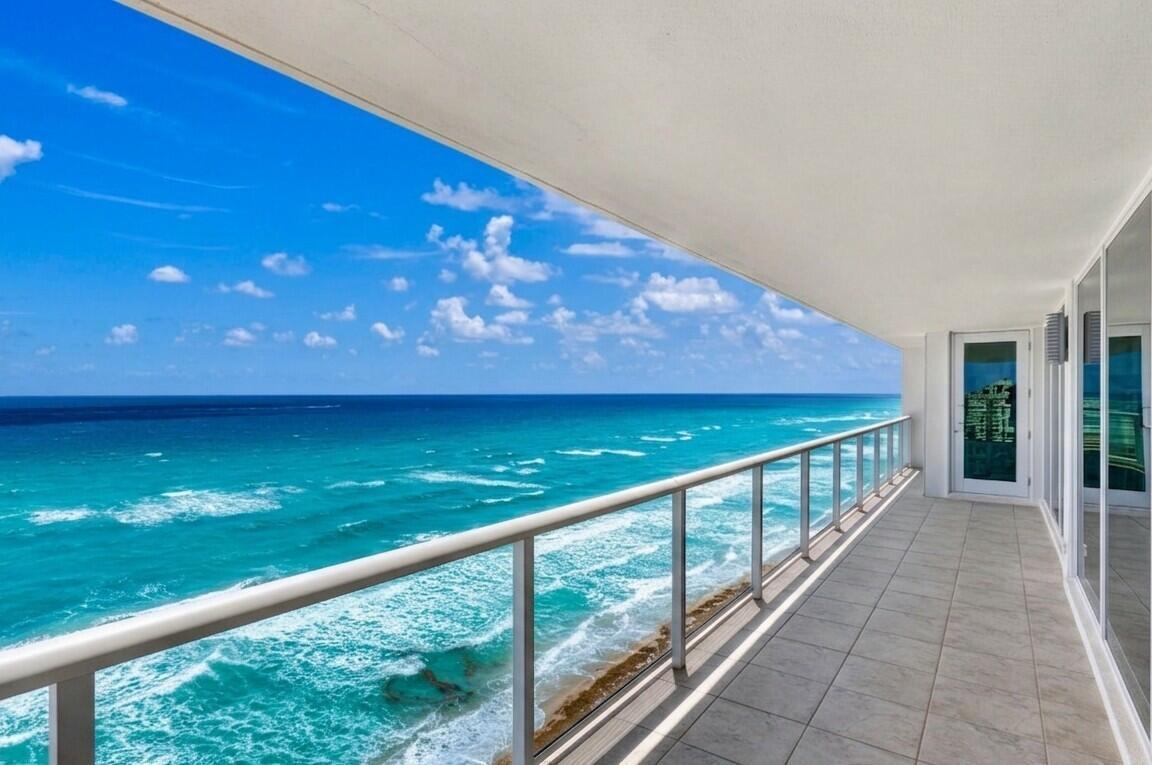 A tiled balcony with a glass railing overlooks the turquoise ocean under a blue sky — 3505 S Ocean Boulevard # 14n, Highland Beach FL 33487, HIGHLAND BEACH, FL