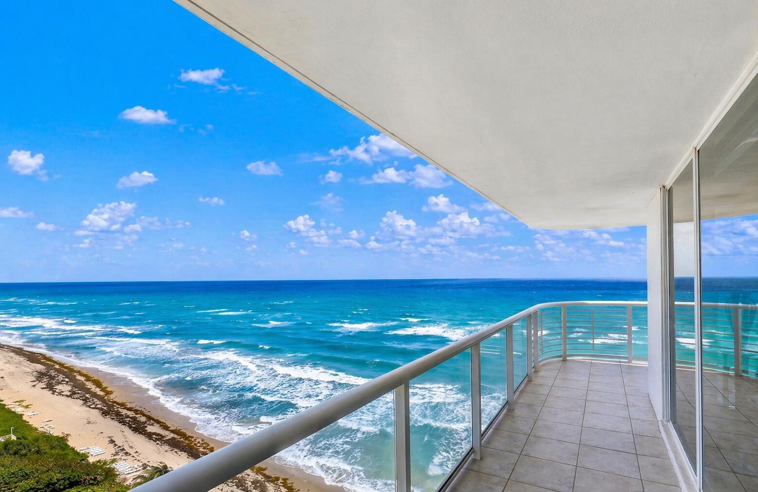 A balcony with tile flooring and a glass railing overlooks the ocean and sandy beach — 3505 S Ocean Boulevard # 14n, Highland Beach FL 33487, HIGHLAND BEACH, FL