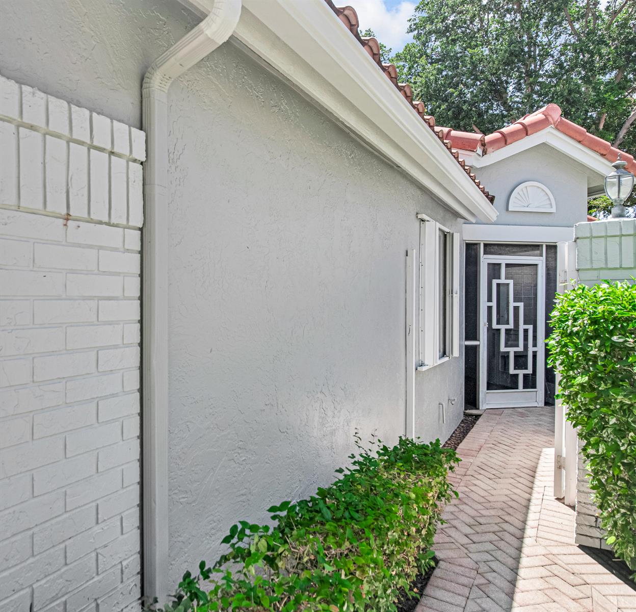 A paved walkway leads to a white front door with geometric glass panels — 9822 Harbour Lake Circle, Boynton Beach FL 33437, BOYNTON BEACH, FL