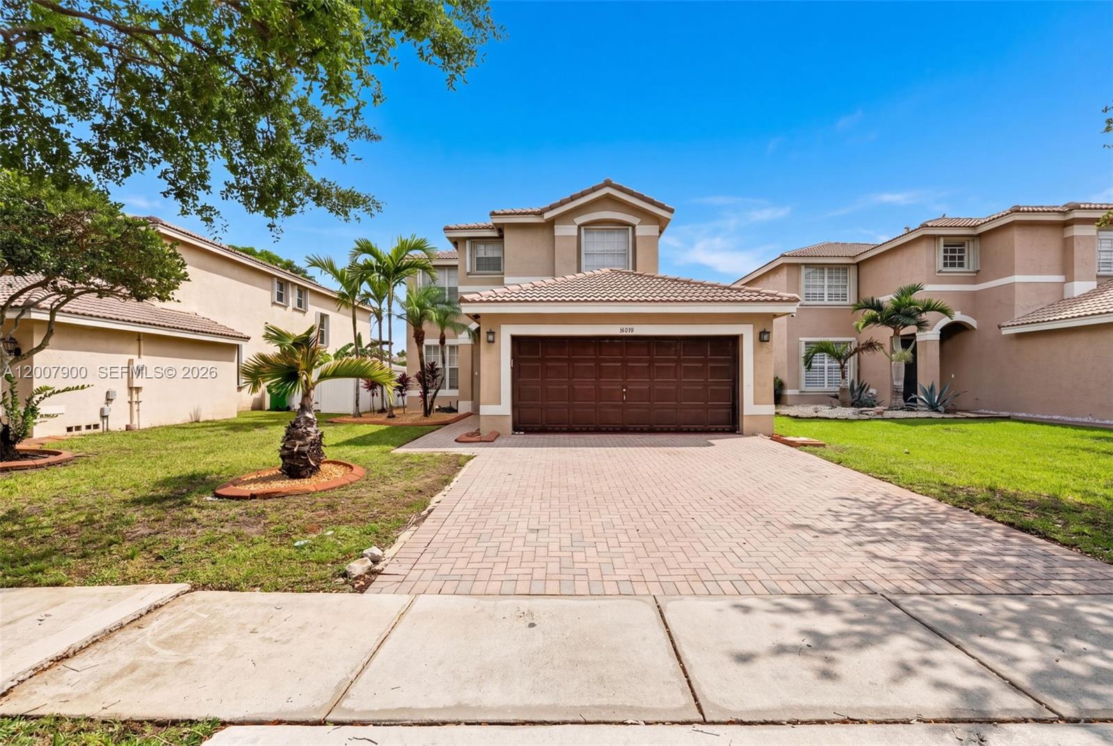 A two-story suburban house features a brown garage door and a paved driveway — 16438 SW 28th St, Miramar FL 33027, MIRAMAR, FL