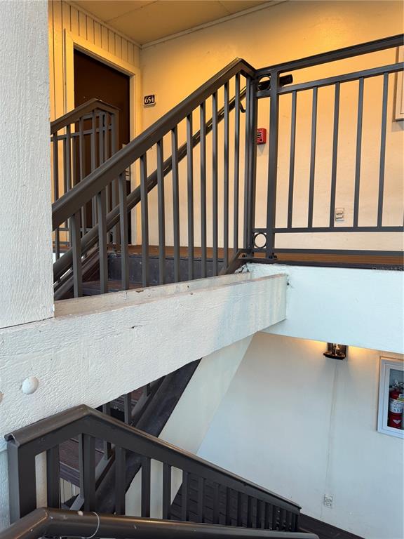 An outdoor staircase with dark metal railings leads to a second-floor apartment entrance — 4782 FOX HUNT DRIVE UNIT D654, WESLEY CHAPEL, FL