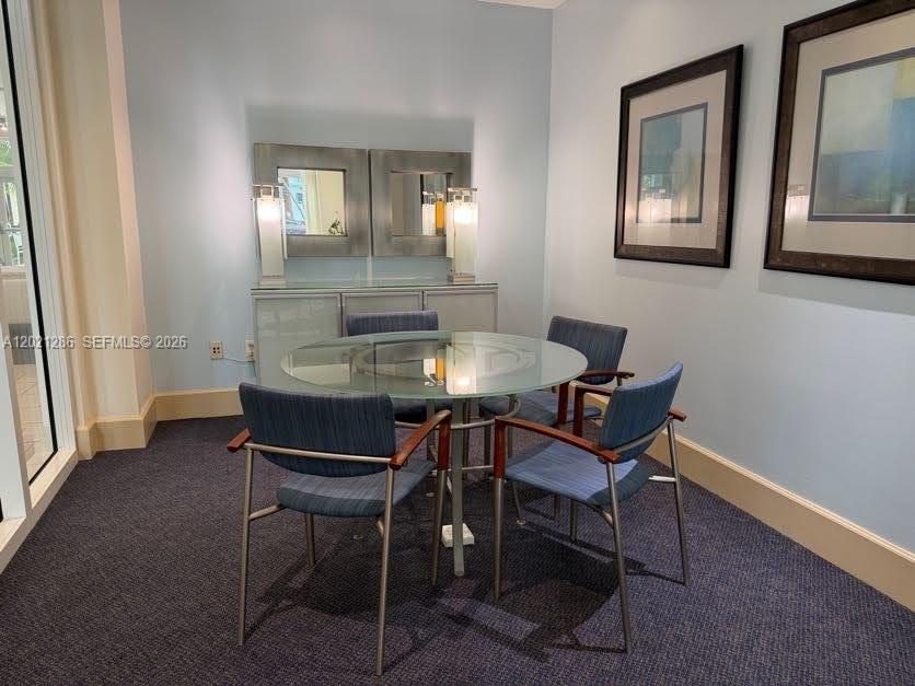 A small conference room features a glass-topped table, four blue chairs, and two framed pictures — 2000 N Bayshore Dr # 126, Miami FL 33137, MIAMI, FL