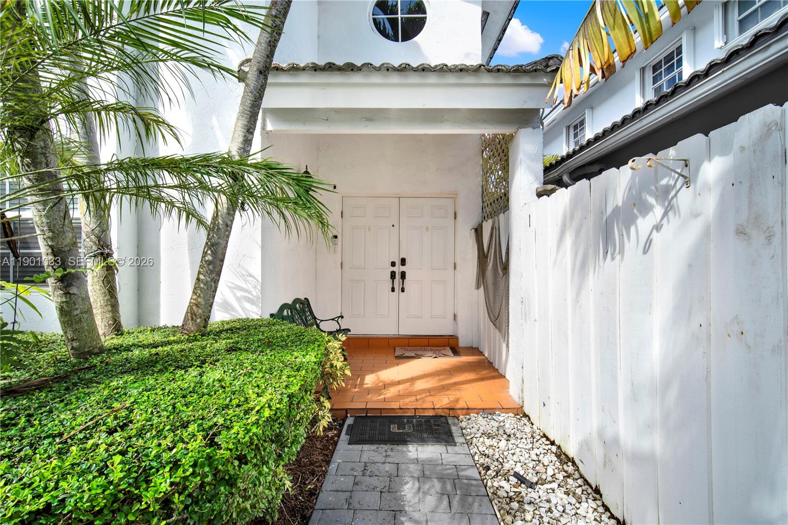 A white house entrance features double doors, a tiled porch, and a stone walkway — 10825 SW 91st Ln, Miami FL 33176, MIAMI, FL