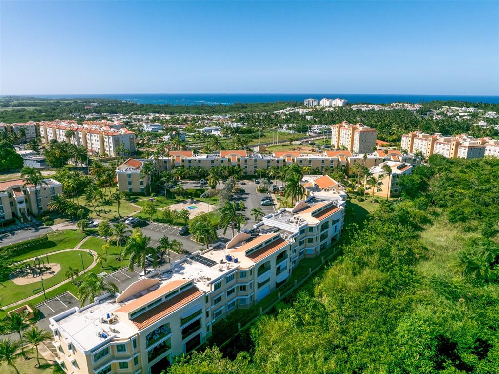 An aerial view shows multiple multi-story apartment buildings surrounded by palm trees and green space — 3104 EL DORADO CLUB UNIT 3104, VEGA ALTA, PR