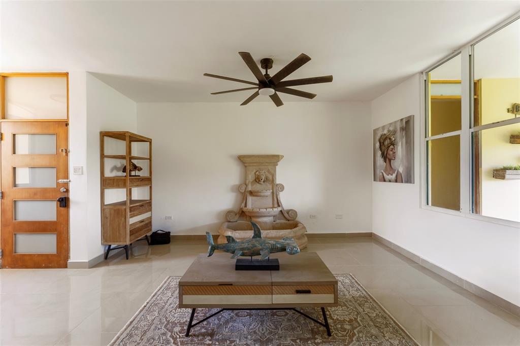 A kitchen features dark cabinets, wood-look wall tiles, a stainless steel range hood, and appliances — 3104 EL DORADO CLUB UNIT 3104, VEGA ALTA, PR