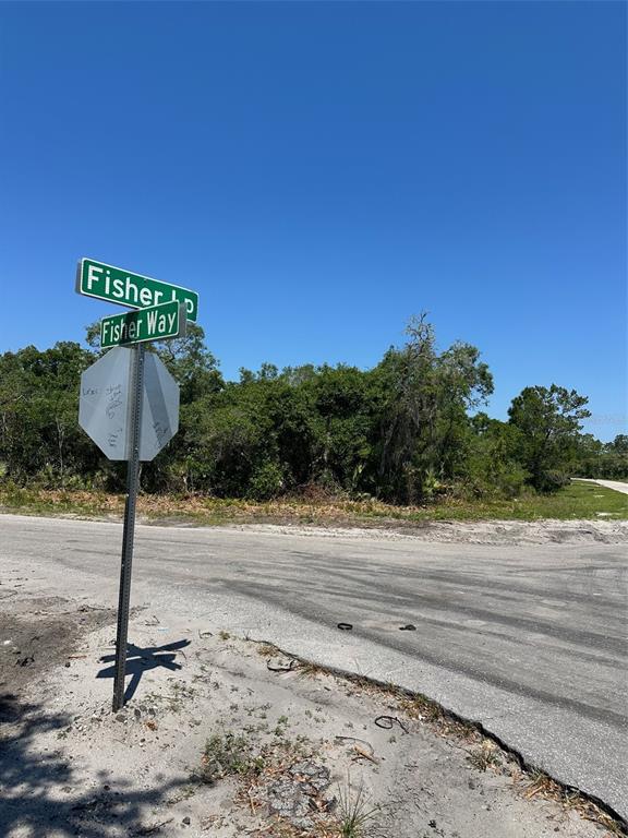 A street sign for Fisher Loop and Fisher Way stands at a rural intersection — TBD FISHER WAY, OCKLAWAHA, FL