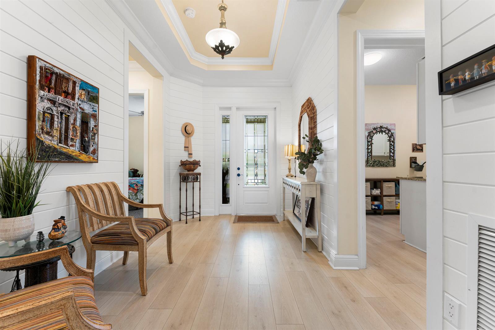 A bright entryway features white shiplap walls, light wood flooring, and a tray ceiling — 16148 Key Biscayne Lane, Westlake FL 33470, WESTLAKE, FL