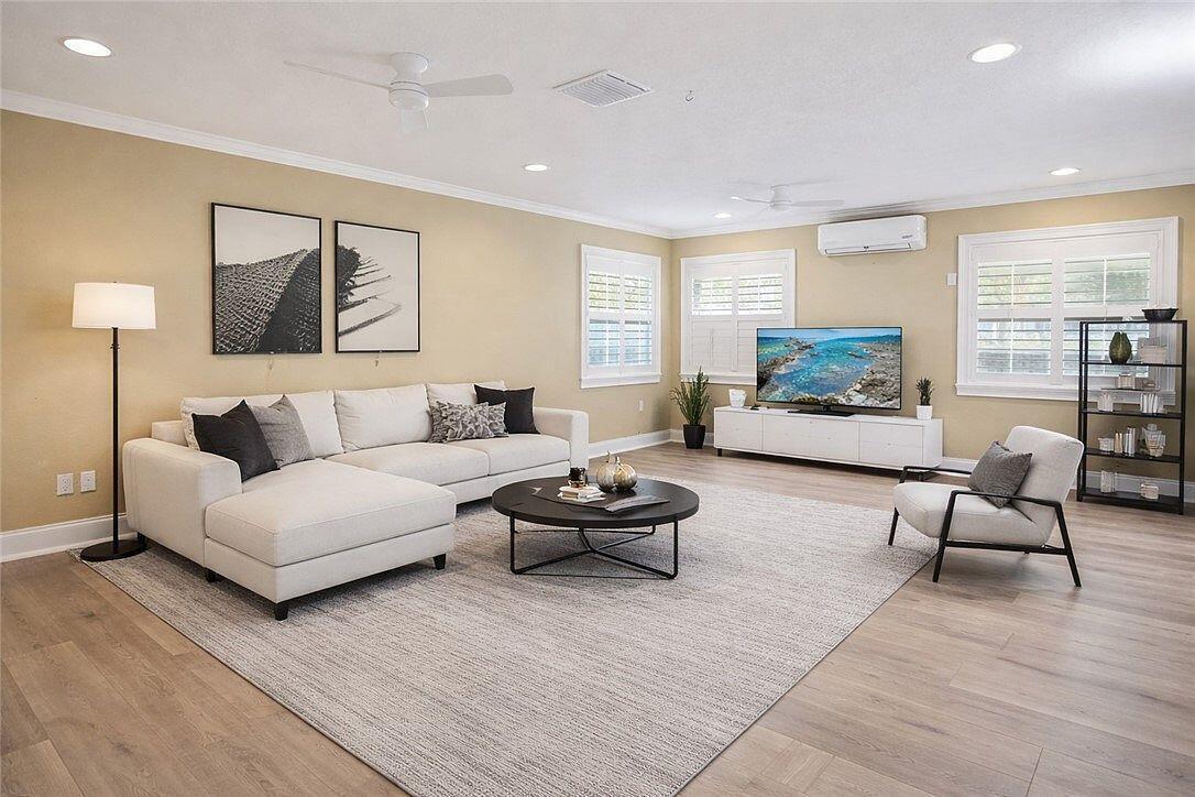 An aerial view shows three waterfront houses with lawns, driveways, and boat docks along a canal — 241 14th Place, Vero Beach FL 32960, VERO BEACH, FL