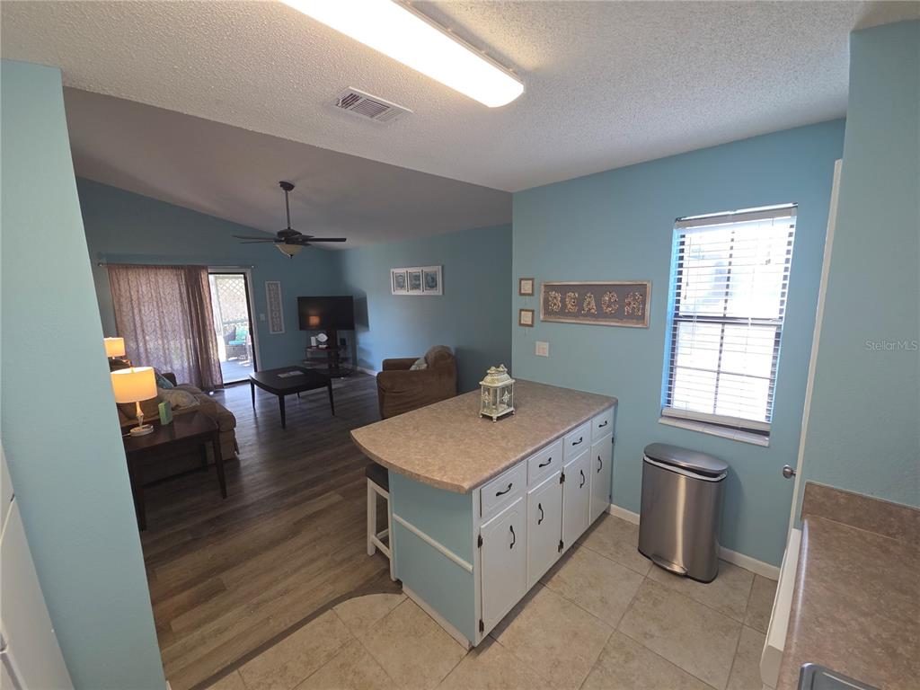 A kitchen island with light blue cabinets sits in a room with light blue walls — 644 16TH STREET, PANAMA CITY BEACH, FL