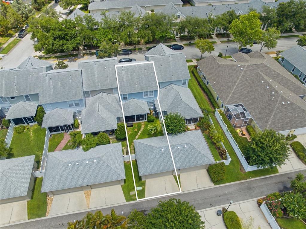 An aerial view shows a blue townhouse with a white-outlined property boundary and garage — 10016 BENTLEY WAY, TAMPA, FL