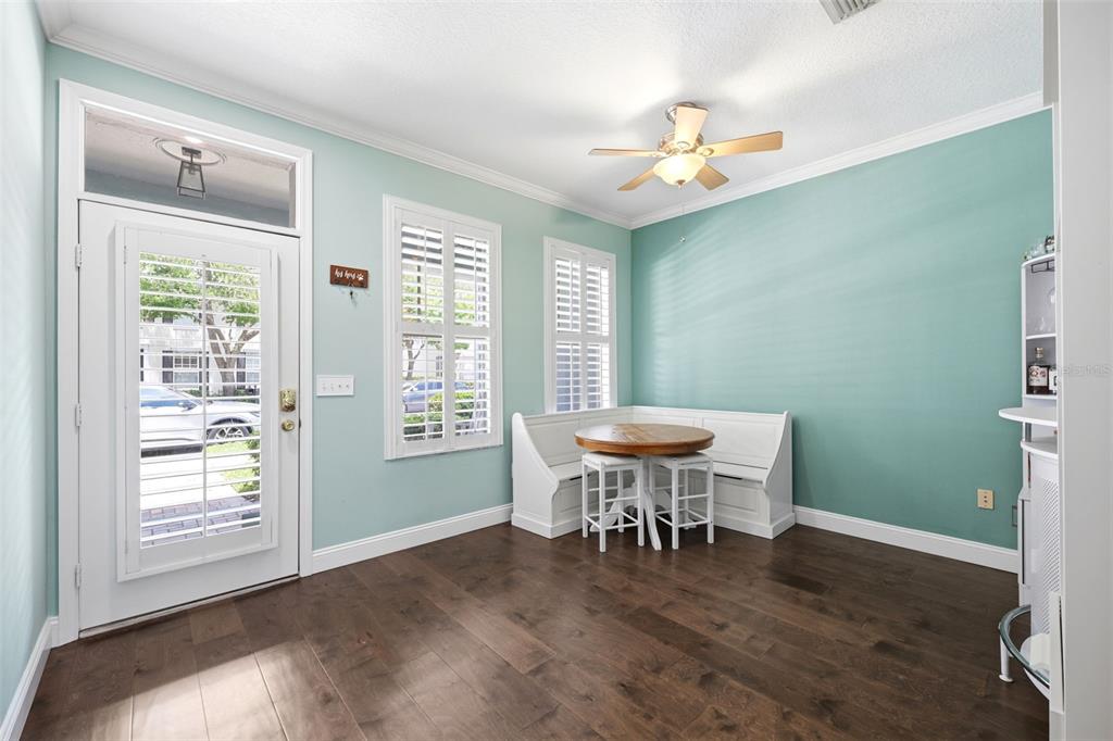 A dining nook with a corner bench, round table, and light blue walls — 10016 BENTLEY WAY, TAMPA, FL
