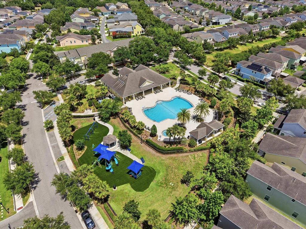 An aerial view shows a community swimming pool, clubhouse, and playground surrounded by residential houses — 11310 WINTHROP LAKE DRIVE, RIVERVIEW, FL