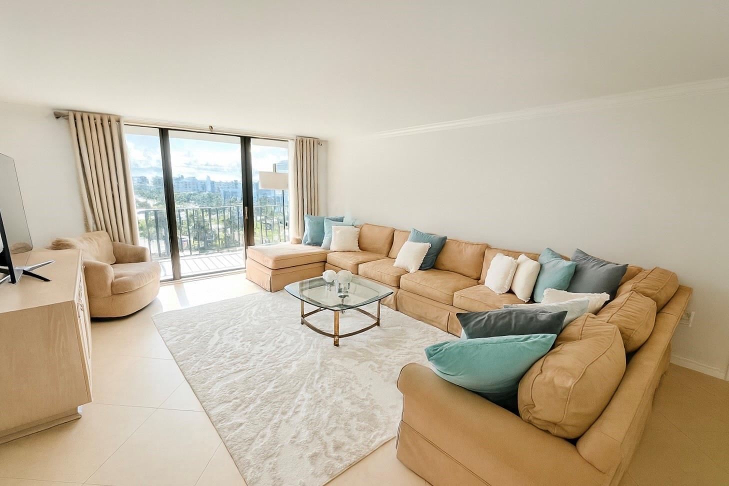 A living room features a large tan sectional sofa, glass coffee table, and balcony view — 3460 S Ocean Boulevard # 608, Palm Beach FL 33480, PALM BEACH, FL