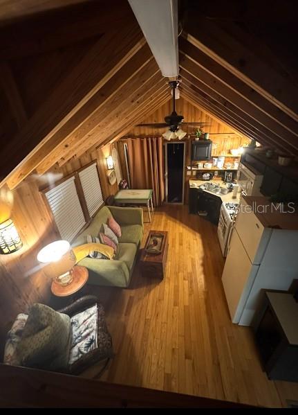 An elevated view of a rustic living room and kitchen with wood-paneled walls and ceilings — 25235 142ND LANE NE UNIT 185, FORT MC COY, FL