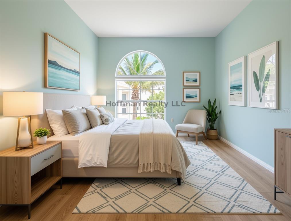 A bedroom with light blue walls, a bed, a large arched window, and wood flooring — 2263 FLETCHERS POINT CIRCLE, TAMPA, FL