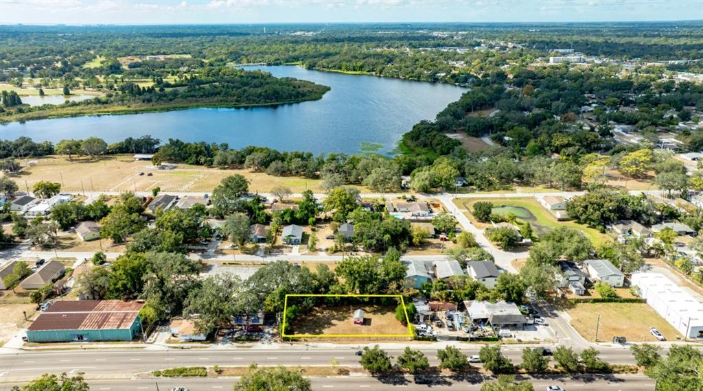 An aerial view shows a vacant rectangular lot highlighted in yellow along a busy road — 8428 N 40TH STREET, TAMPA, FL