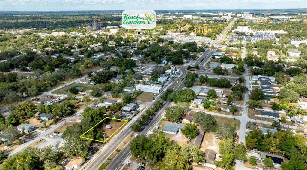 This aerial view shows a vacant lot outlined in yellow along a suburban road — 8428 N 40TH STREET, TAMPA, FL