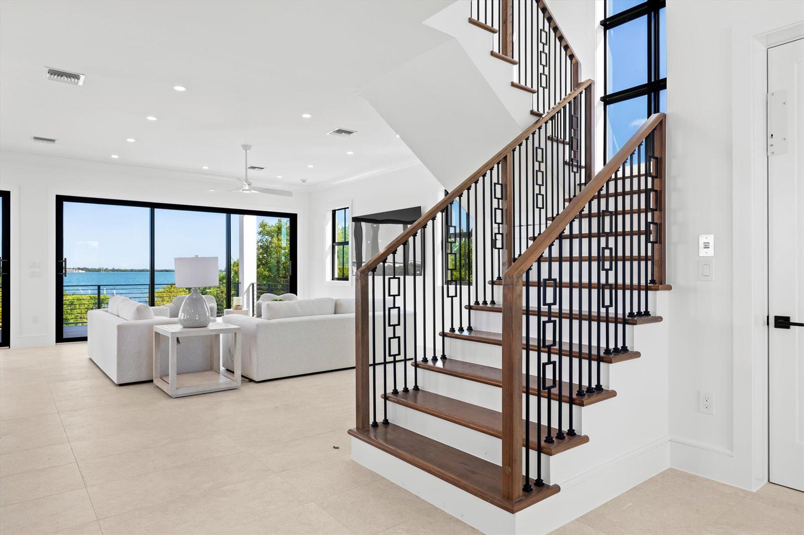 A backyard swimming pool and raised spa with blue tile finishes and light stone decking — 231 E Shore Drive Unit 6, Key West FL 33040, KEY WEST, FL