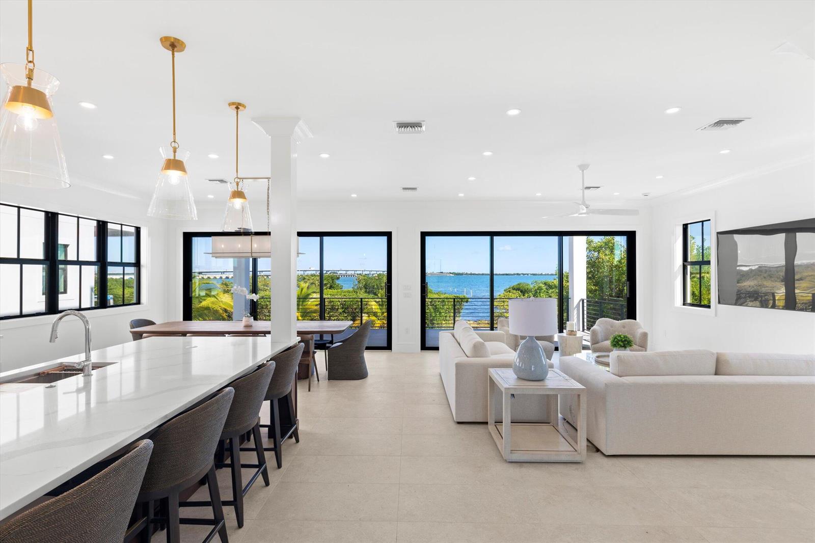An entryway with a mirror and console table leads to an open kitchen and living area — 231 E Shore Drive Unit 6, Key West FL 33040, KEY WEST, FL