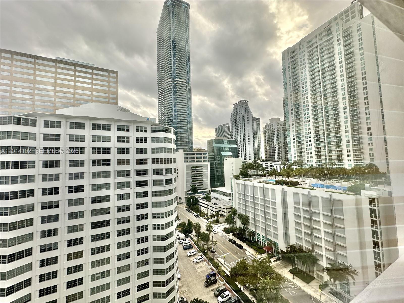 An elevated view of a city street surrounded by multiple high-rise apartment and office buildings — 825 Brickell Bay Dr # 1751, Miami FL 33131, MIAMI, FL