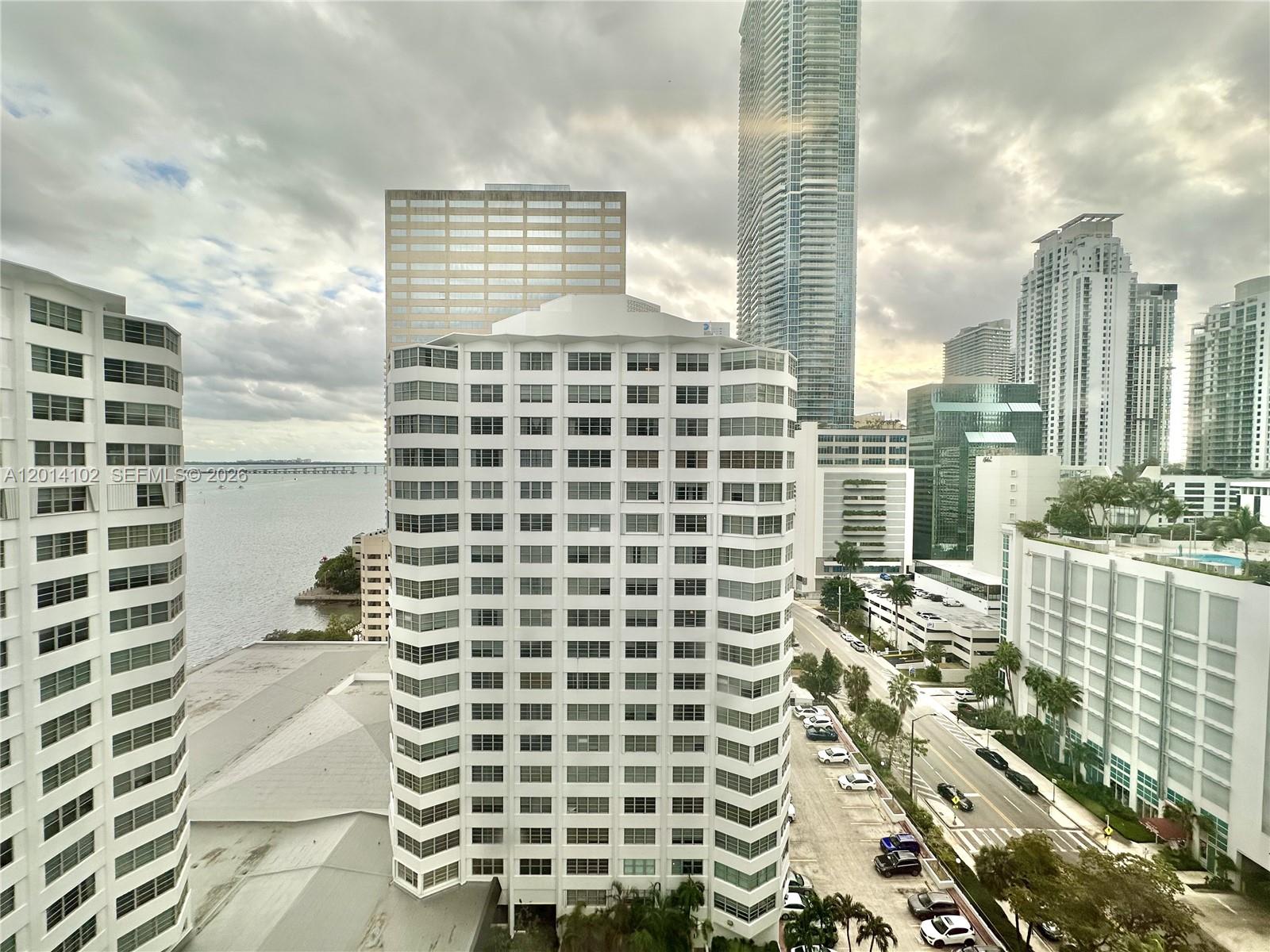 An elevated view of a city skyline featuring multiple high-rise buildings and a waterfront — 825 Brickell Bay Dr # 1751, Miami FL 33131, MIAMI, FL