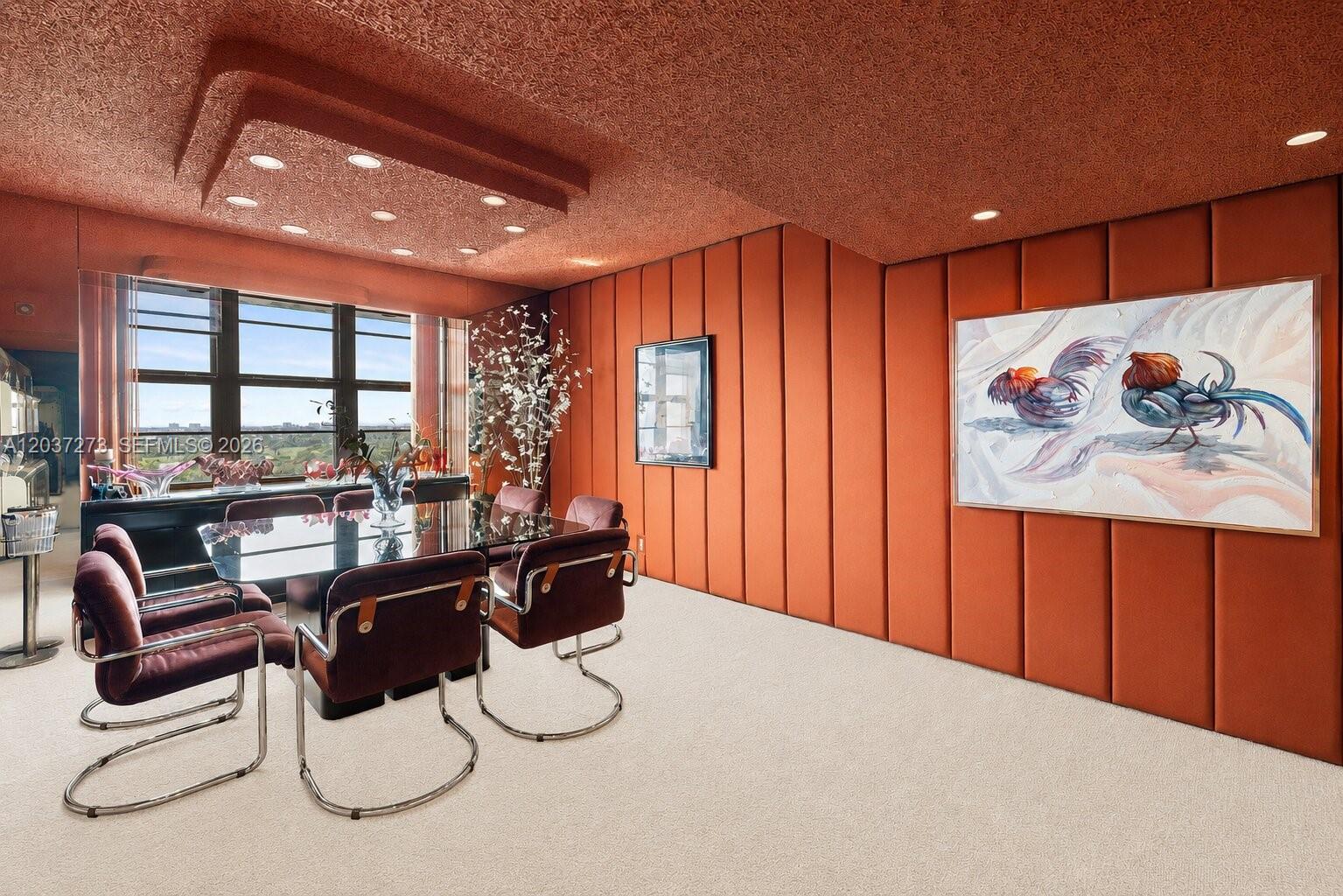 A dining room features orange upholstered wall panels, a textured ceiling, and a glass table — 5500 Collins Ave # 1401, Miami Beach FL 33140, MIAMI BEACH, FL