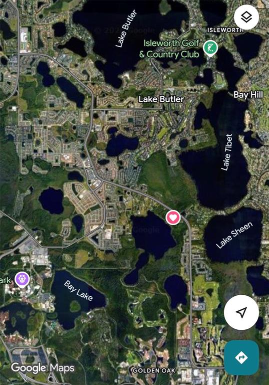 An aerial view shows a wooded property with a boardwalk leading to a lake — 8834 WINTER GARDEN VINELAND ROAD, ORLANDO, FL