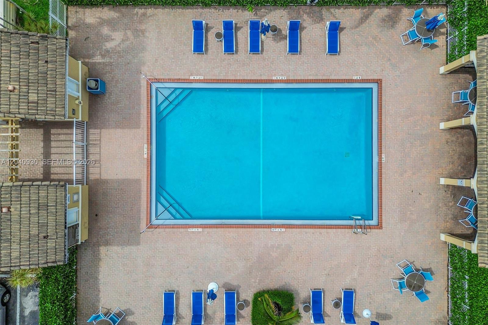 An aerial view shows a rectangular swimming pool surrounded by a brick patio and lounge chairs — 12361 SW 123rd Ter, Miami FL 33186, MIAMI, FL